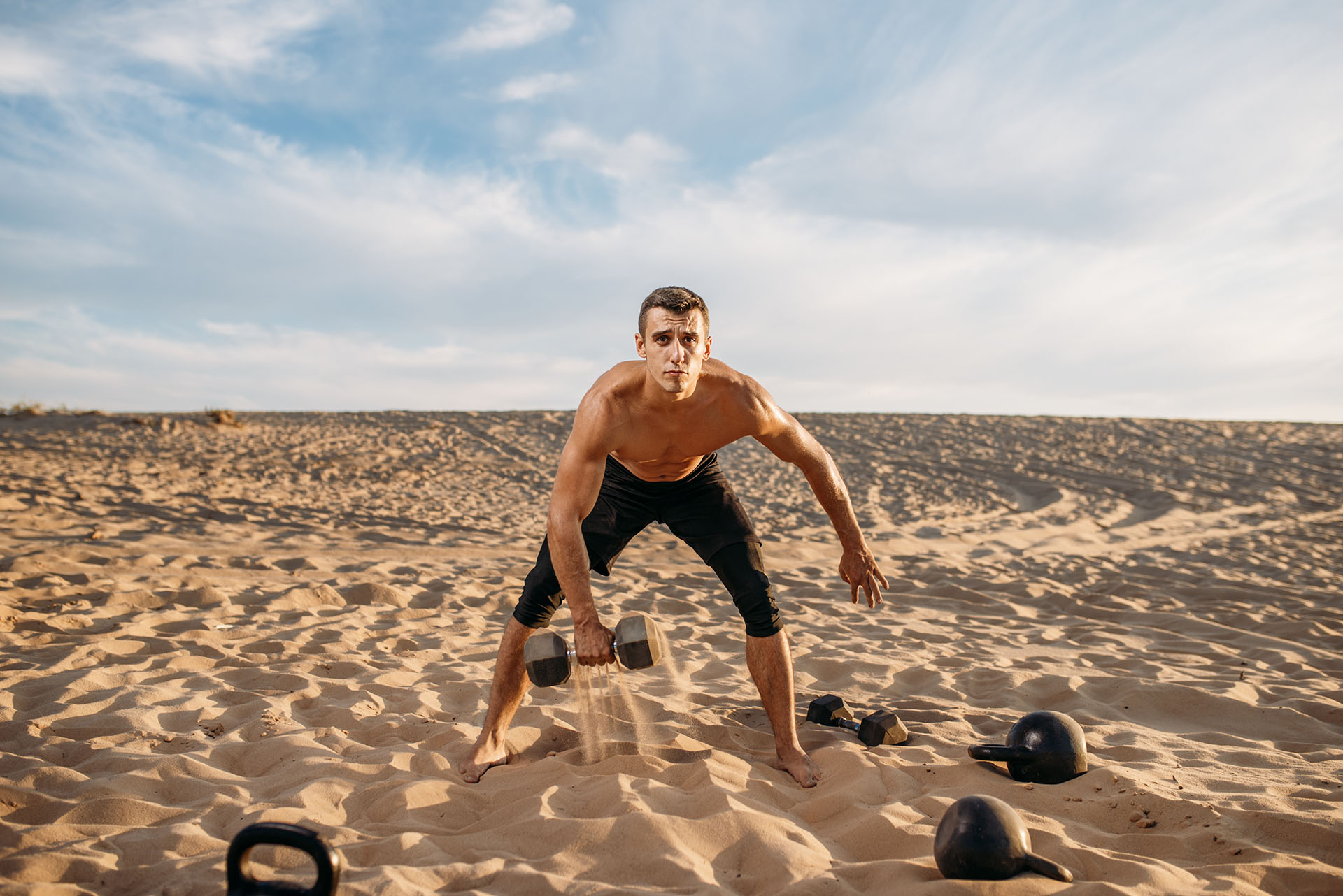 Sports Man training in sand